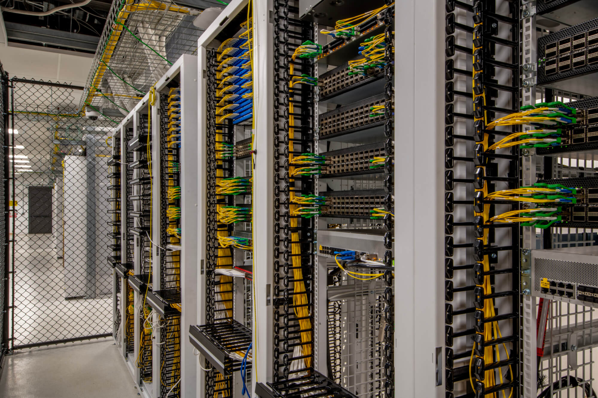 A large server room with various electrical components.