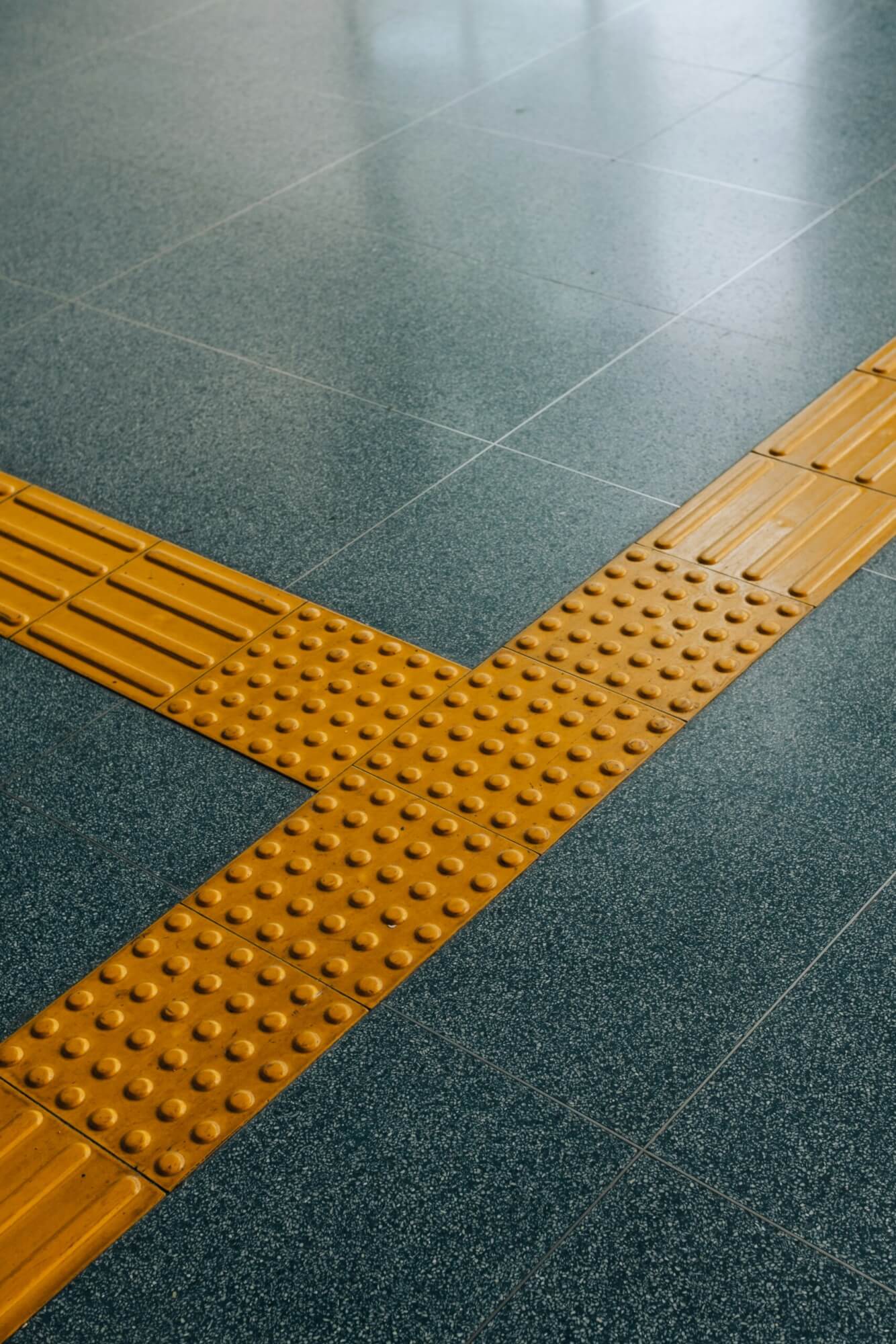 An yellow ADA Compliant sidewalk tile picture.