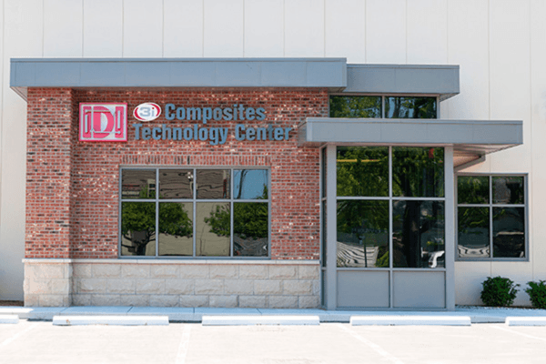 A picture of the outside of a brick building that says IDI 3i Composites Technology Center.