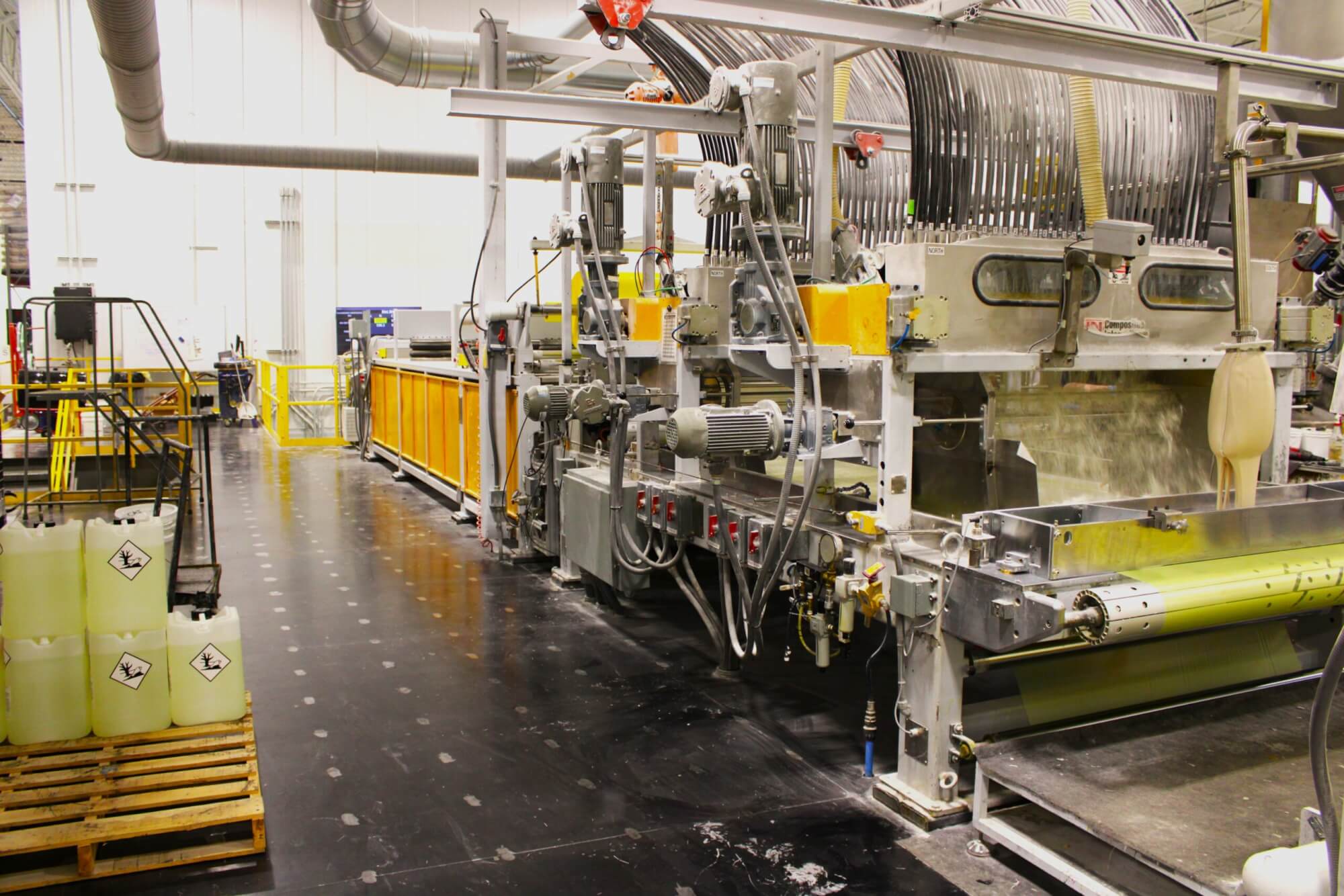 A picture of a SMC machine line with a white SMC material being made on the SMC line.