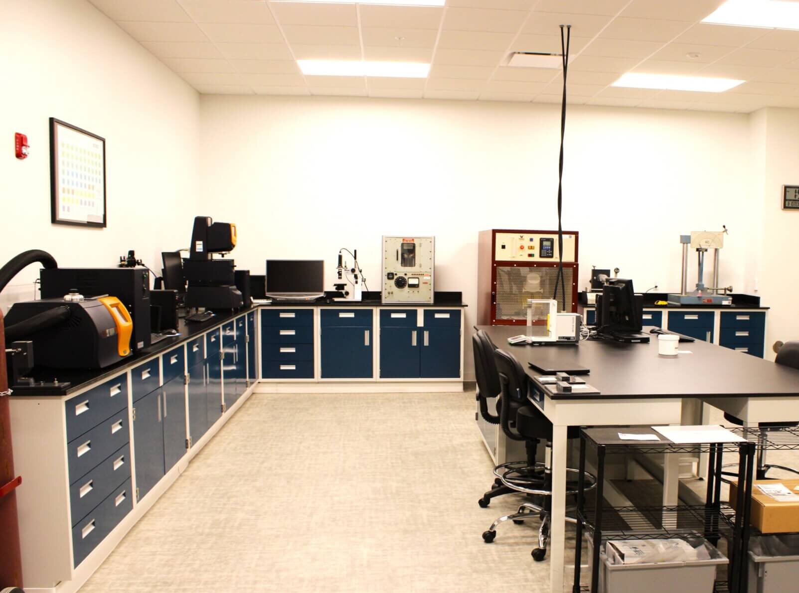 A picture of a lab with multiple lab machines used for a variety of testing of SMC materials.