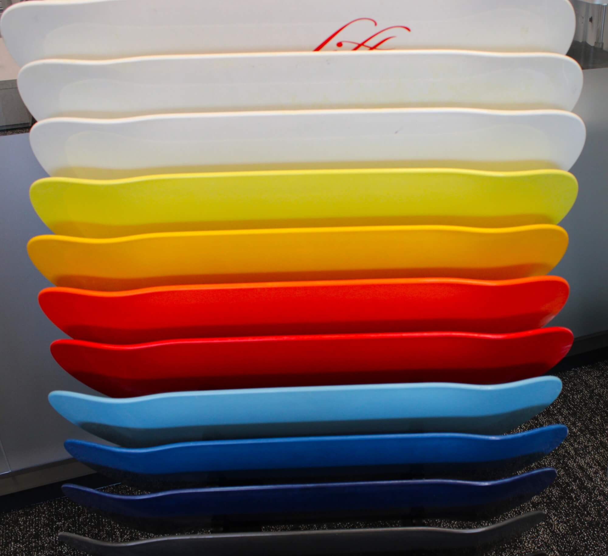 Eleven skateboard parts in a variety of colors.