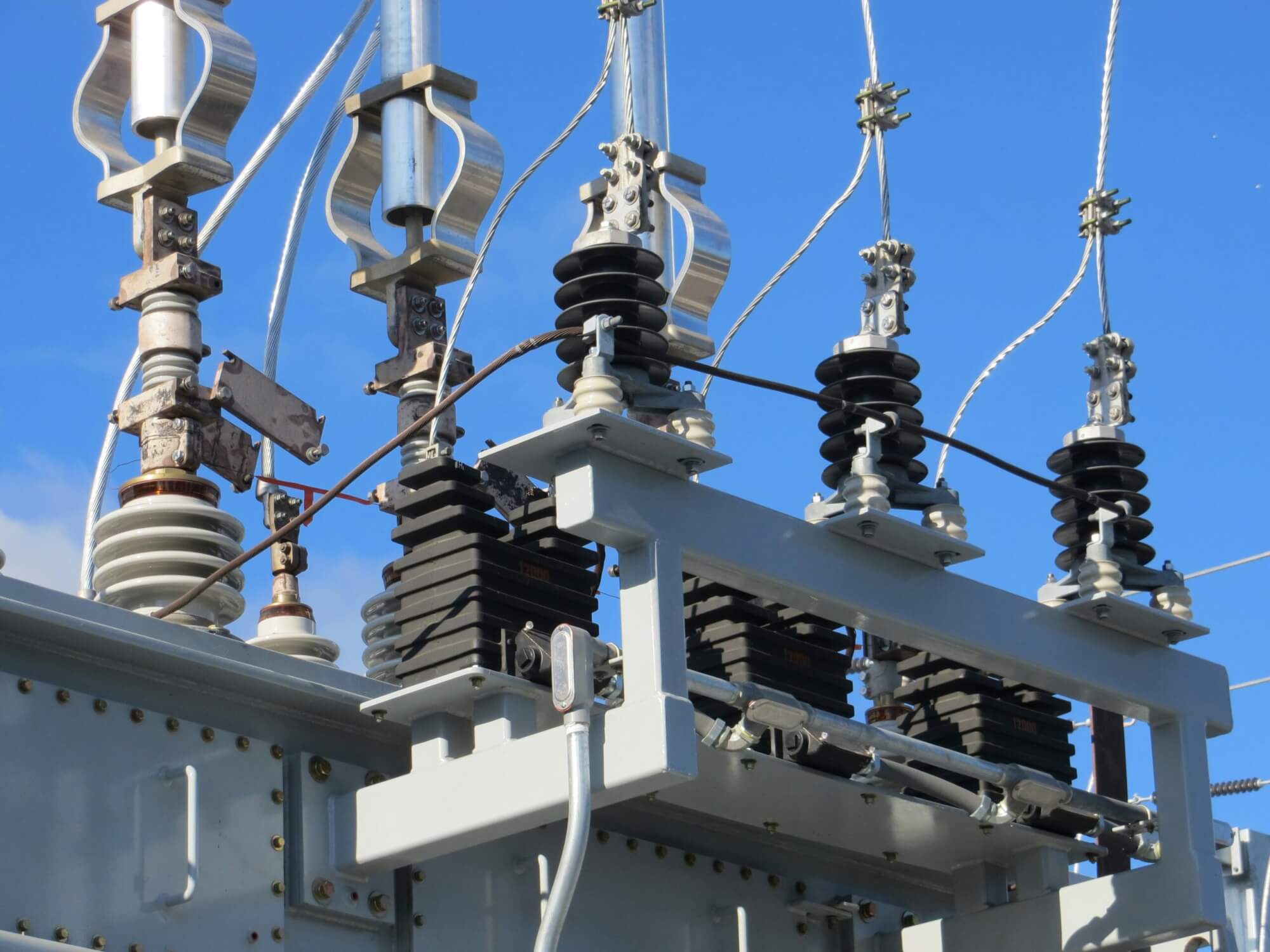 A medium voltage industrial circuit breaker with a blue sky background.