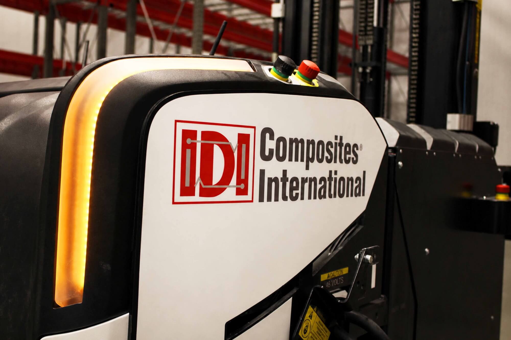 AN Automated Guided Vehicle with a decal on the side that says IDI Composites International.