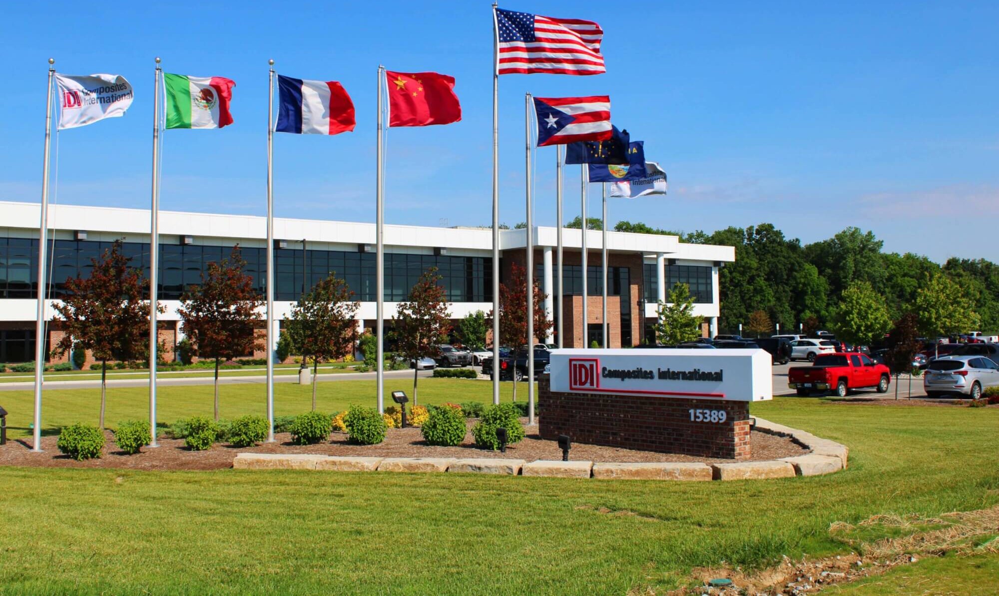 image of IDI headquarters, the building with 9 flags in front of it representing different locations